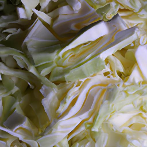 Cutting the cabbage into pieces helps to shred it evenly using a food processor.